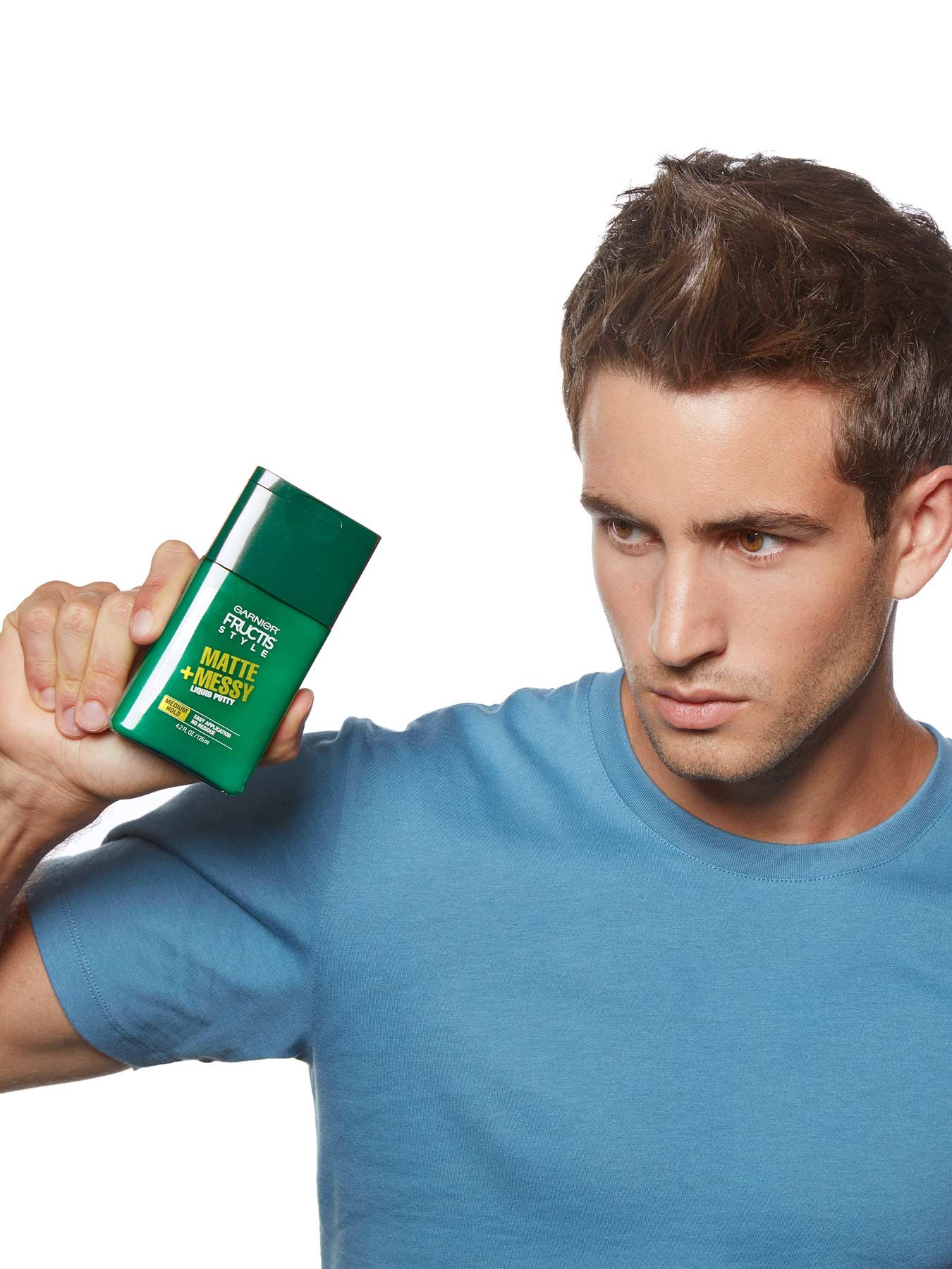 Model holding Matte and Messy Liquid Hair Putty for Men, No Drying Alcohol.